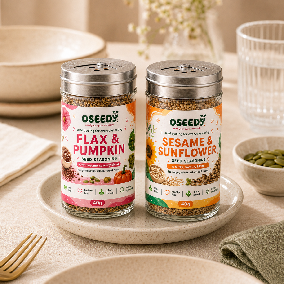 Two jars of Oseedy seed seasoning - Flax & Pumpkin and Sesame & Sunflower - displayed together on a ceramic plate.